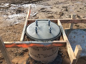Poured sono-tube with anchor bolts